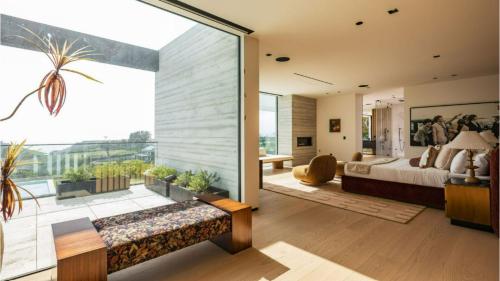 a bedroom with a bed and a large window at The Dume Legacy in Malibu