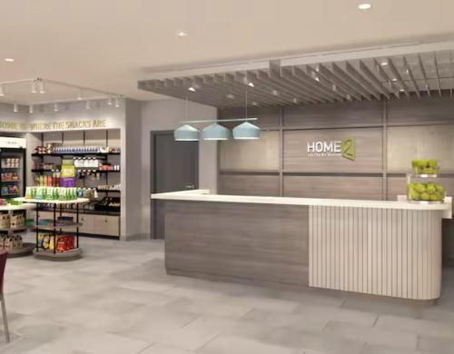 a grocery store with a counter in the middle at Home2 Suites By Hilton Syracuse Liverpool Airport Area in Liverpool