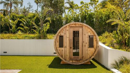 a wooden hobbit house in a garden at The Dume Legacy in Malibu