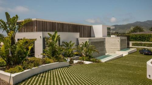 a house with a garden in front of it at The Dume Legacy in Malibu