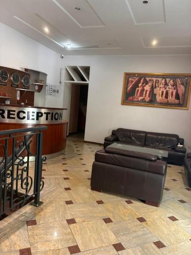 a waiting room with two leather couches and a bar at Boutique Hotel Taste Tbilisi in Tbilisi City