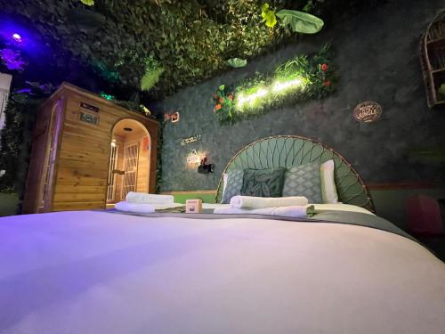 a bedroom with a large bed in a room at Jungle Room Jacuzzi Ambiance Tropicale in Épernay