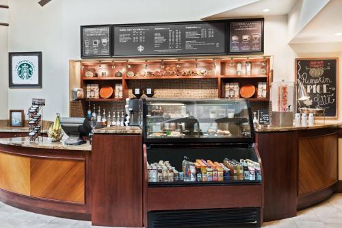 a restaurant with a counter with food on display at Austin Marriott North in Round Rock