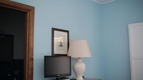 a lamp sitting on a table next to a tv at Relais Masseria Cardillo in Metaponto