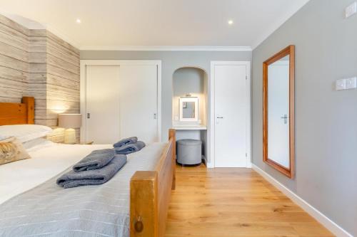 a bedroom with a bed and a mirror at 1 Bed in Newtonmore oc-a32412 in Newtonmore
