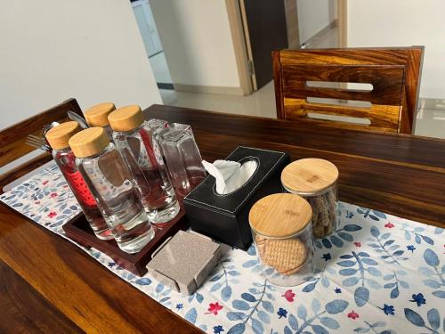 a wooden table with a tray with bottles and containers at Luna Spaces- BLUES Nr Mumbai International Airport in Mumbai
