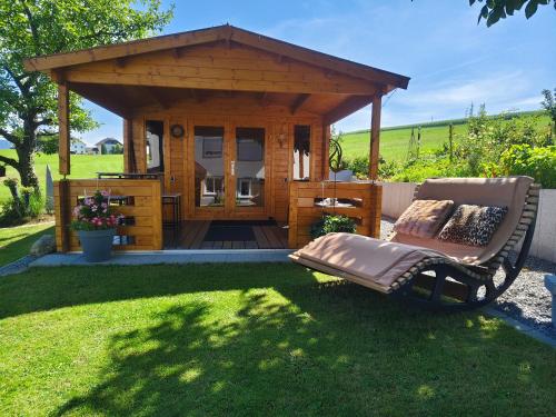 a gazebo with a bench in a yard at Ferienhof Schaubmeier in Klaffer am Hochficht