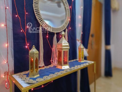two lamps on a table with a mirror and lights at BnBBuddy 2 BR Anugraha, Dwarka in New Delhi