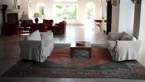 a living room with two white couches and a coffee table at Relais Masseria Cardillo in Metaponto