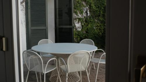 a white table and chairs on a patio at Relais Masseria Cardillo in Metaponto