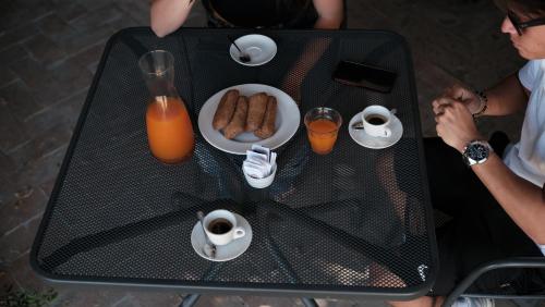 two people sitting at a table with a plate of food at Relais Masseria Cardillo in Metaponto