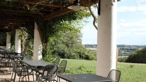 a row of tables and chairs on a patio at Relais Masseria Cardillo in Metaponto