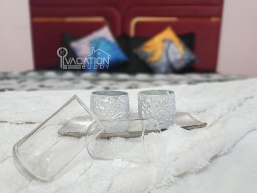 two clear glasses sitting on top of a table at BnBBuddy 2 BR Anugraha, Dwarka in New Delhi
