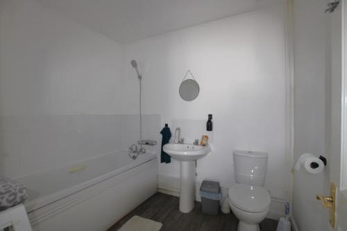 a white bathroom with a toilet and a sink at Saddlebrook 284 in Warden