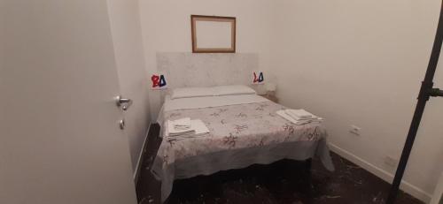 a small bedroom with a bed in a room at A Casa di Filo in Bologna