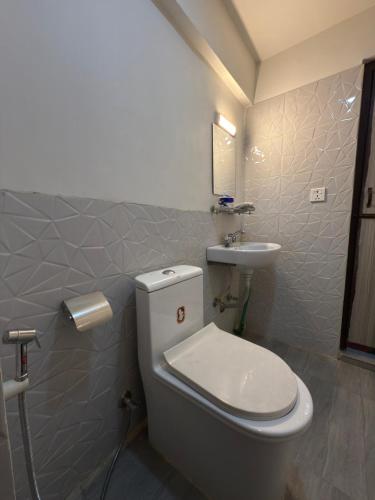 a bathroom with a white toilet and a sink at Cityview Guest House in Kathmandu