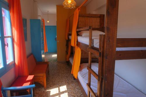 a room with three bunk beds in a room at Chrissi Ammos in Perissa