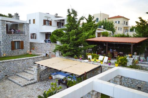 a view of a house with a table and a building at Malvazios Villas #8 in Gythio