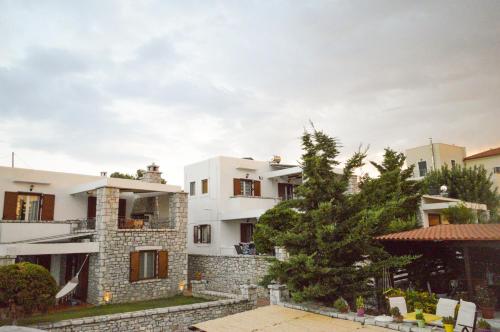 a white building with a tree in front of it at Malvazios Villas #8 in Gythio
