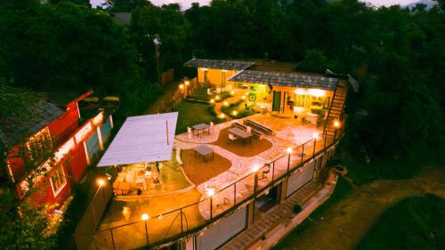 an overhead view of a building with a patio at night at Jaadooghar Madcap Mudhouse in Palāhu