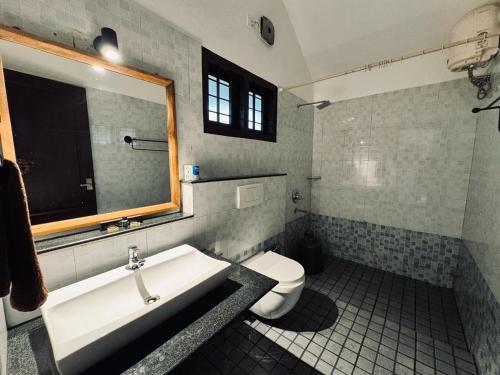 a bathroom with a sink and a toilet at Dhanagiri Homestay Wayanad in Vythiri