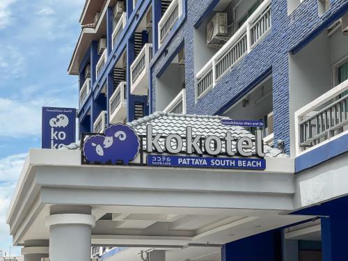 a building with a sign on the side of it at Kokotel Pattaya South Beach in Pattaya