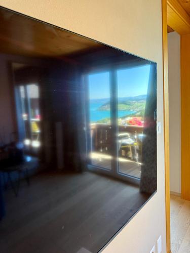 a view of a living room with a view of the ocean at Eva's Seeblick in Krattigen
