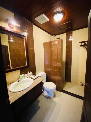 a bathroom with a sink and a toilet and a shower at Maison Vongprachan Classic in Luang Prabang