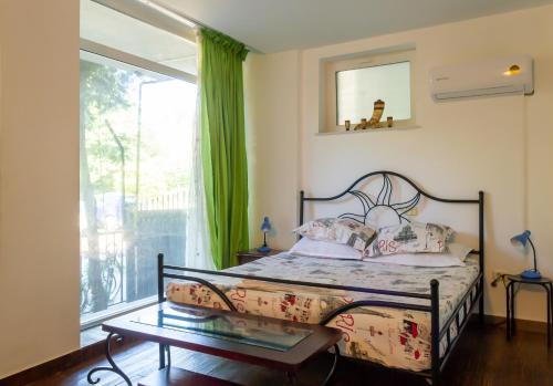 a bedroom with a bed and a large window at ElStefanino House in Eforie Nord