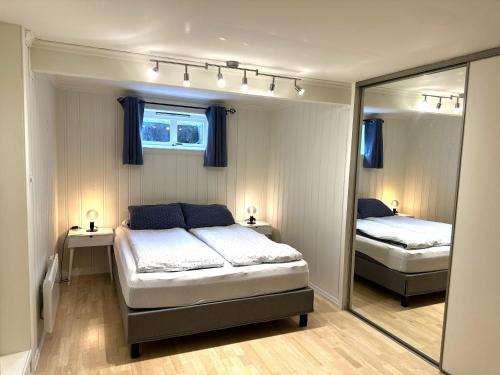 a bedroom with two beds and a mirror at Apartment Porsgrunn - Bright, spacious, comfortable in Porsgrunn