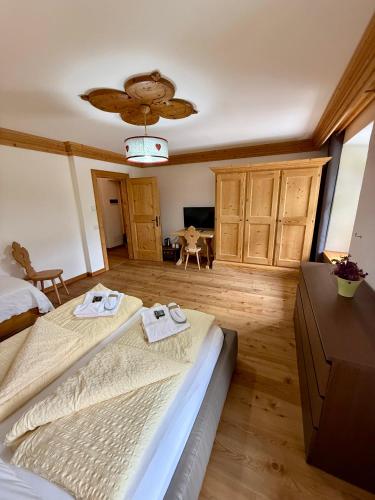 a bedroom with a large bed with towels on it at Rifugio Ospitale in Cortina dʼAmpezzo