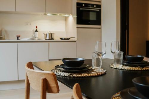 a kitchen with a table with plates and glasses at Naest - Authentic Escapes City House Nijmegen in Nijmegen