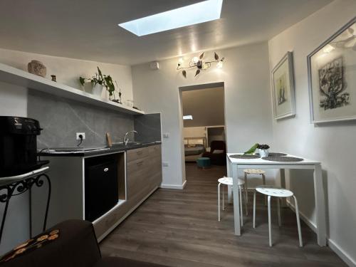 a kitchen with a sink and a counter with stools at Boutique House in Benevento