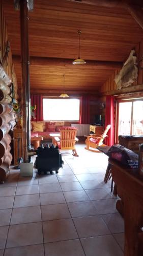 a large living room with a table and chairs at Le Domaine de la Vergnolle in Roches