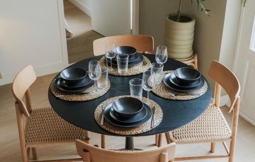 a black dining room table with black hats and chairs at Naest - Authentic Escapes City House Nijmegen in Nijmegen
