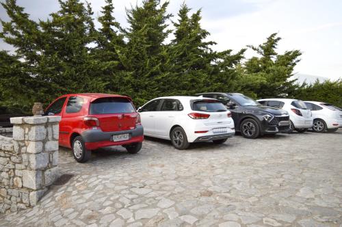 a group of cars parked in a parking lot at Malvazios Villas #7 in Gythio