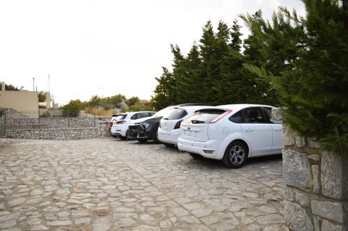 a row of cars parked in a parking lot at Malvazios Villas #7 in Gythio