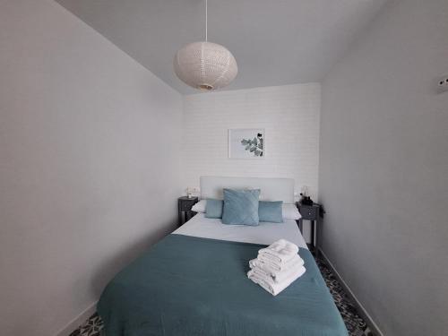 a bedroom with a bed with towels on it at La casita de Evita in Setenil
