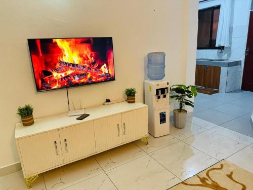 a living room with a fire on the wall at MJ Homes Mombasa - Cosy and lavish 2 bedroom apartment master ensuite unit in Mombasa