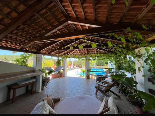 an outdoor patio with a wooden pergola at Room with swimming pool Gorana in Jelsa
