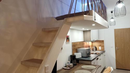 a stairway in a kitchen with a microwave at Apartment Tiny Style in Vohenstrauß