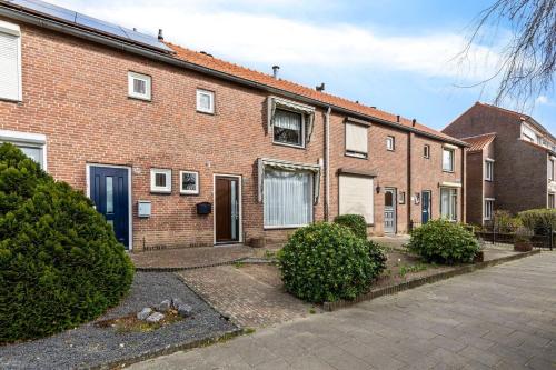 a brick house with a driveway in front of it at Entire Villa, free breakfast, free parking in Veldhoven