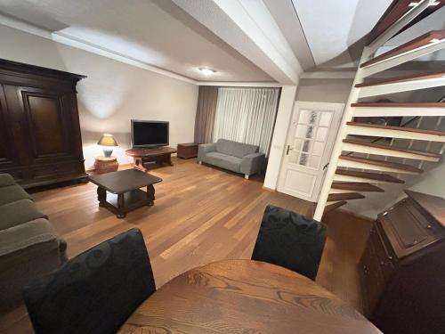a living room with a staircase and a couch at Entire Villa, free breakfast, free parking in Veldhoven