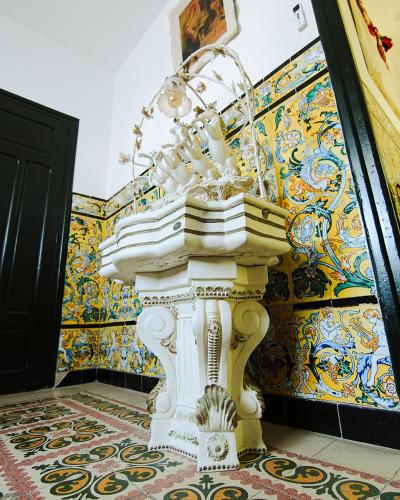 a white sink in a room with colorful walls at DAR EL HAMRA in Mahdia