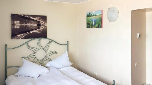 a bedroom with a bed with white sheets and pillows at ElStefanino House in Eforie Nord
