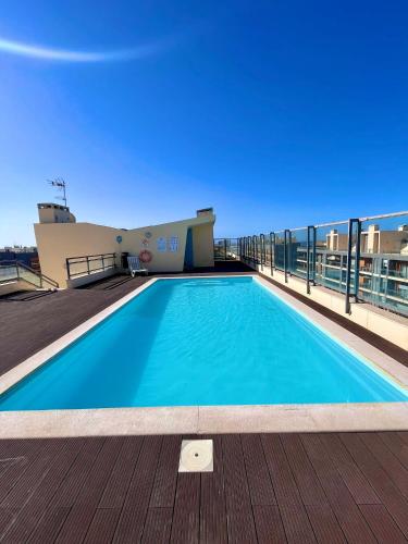 a swimming pool on the roof of a building at Casa Custodio in Olhão