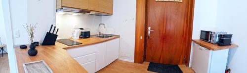 a kitchen with a sink and a counter with a microwave at Ski View - CieloAlto Cervinia in Breuil-Cervinia