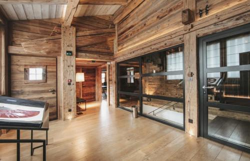 a large room with wooden walls and wooden floors and windows at Winter Deluxe Chalet Megève in Megève