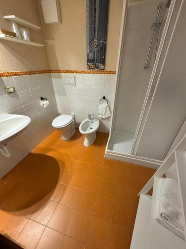 a bathroom with two toilets and a sink and a shower at Maison Maribel in Pré-Saint-Didier