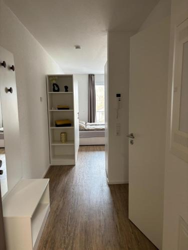 an empty room with a white cabinet and a door at Queen Apartment in Metzingen